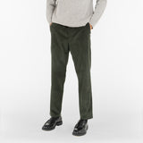 model wears AGELESS CORDUROY PANTS / VERDE MILITARE