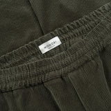MONOBI label detail of AGELESS CORDUROY PANTS / VERDE MILITARE