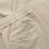 back pocket and NFC tag details of AGELESS CORDUROY PANTS / GESSO