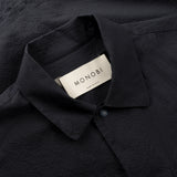 collar and label details of the seersucker short sleeved shirt in blue colour