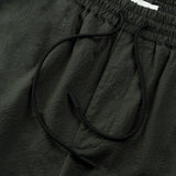 drawstring detail of the seersucker shorts in deep green colour