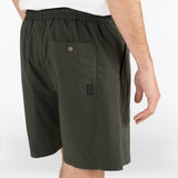 model is wearing seersucker drawstring shorts in deep green colour