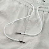 drawstring detail of the seersucker shorts in grey colour