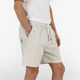 model is wearing seersucker drawstring shorts in grey colour
