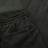 back pocket detail of the seersucker drawstring pants in deep green colour
