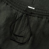 drawstring detail of the seersucker pants in deep green colour