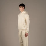 Model wears Superior Wool Loungewear Hoodie color naturale, 3/4