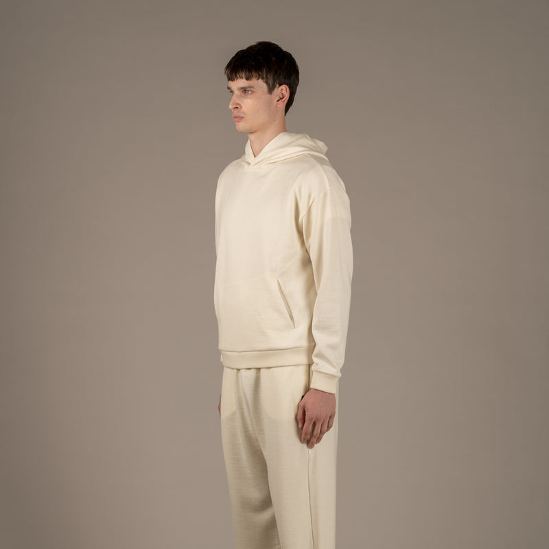 Model wears Superior Wool Loungewear Hoodie color naturale, 3/4