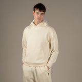 Model wears Superior Wool Loungewear Hoodie color naturale