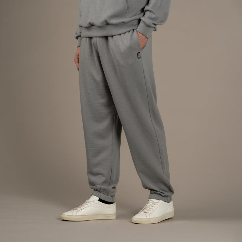 Model wears superior wool loungewear joggers color grey