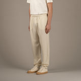 Model wears superior wool loungewear joggers color naturale, 3/4