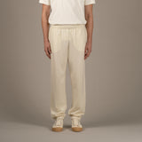 Model wears superior wool loungewear joggers color naturale, front