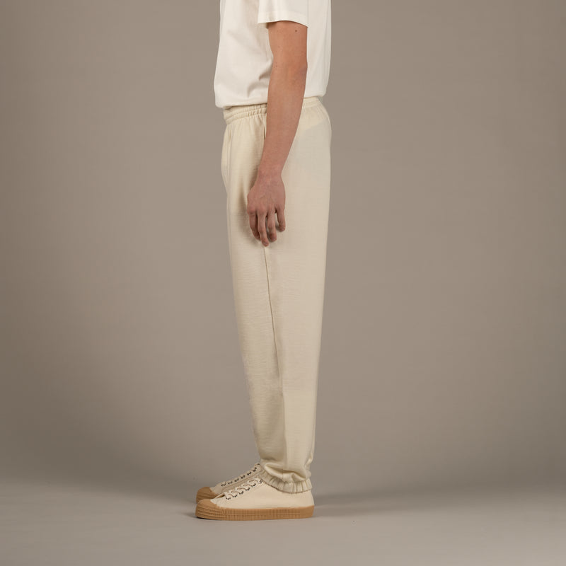 Model wears superior wool loungewear joggers color naturale, side