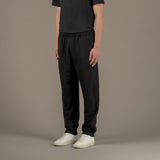 Model wears superior wool loungewear joggers color black, 3/4