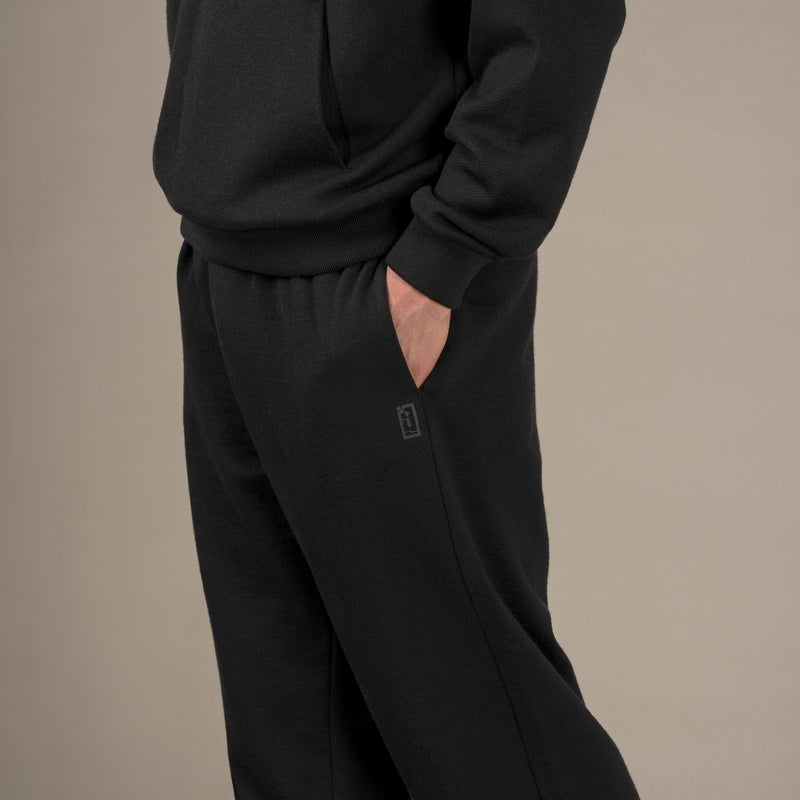 Model wears superior wool loungewear joggers color black